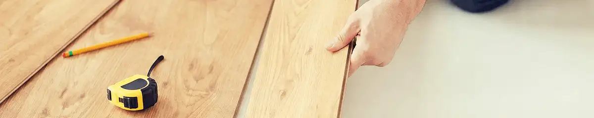 A professional installing wood flooring in Boca Raton, FL