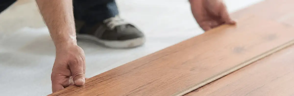 A professional installing laminate flooring in Boca Raton, FL
